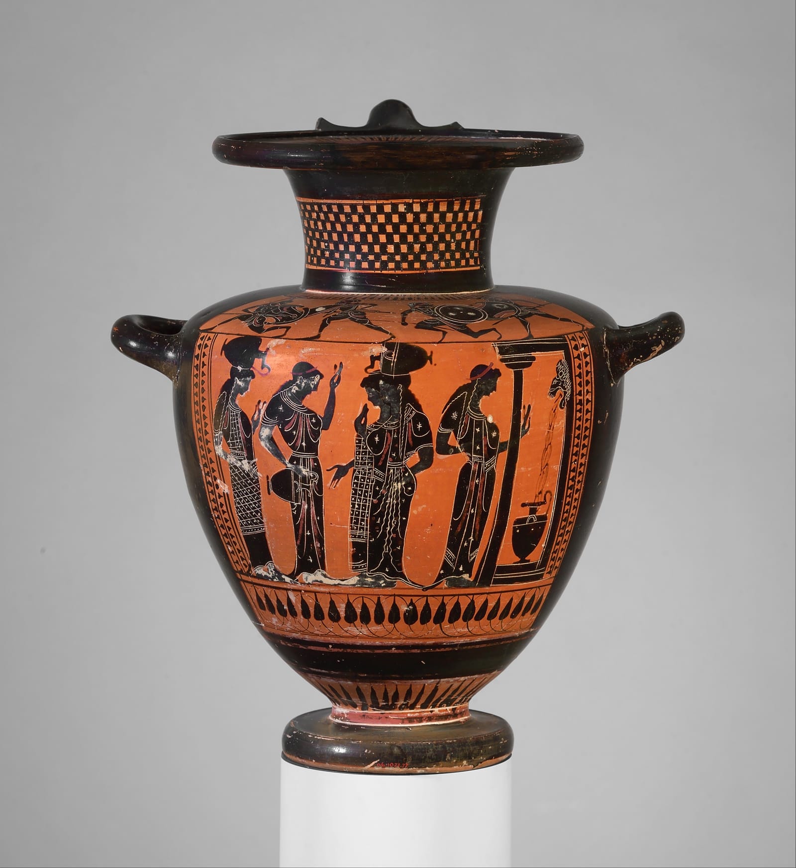 A black-figure water jar painted with four women in patterned dresses at a fountain house; on the right, water runs from a spout into a jar standing below.